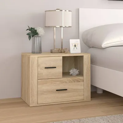 A wooden nightstand next to a bed.