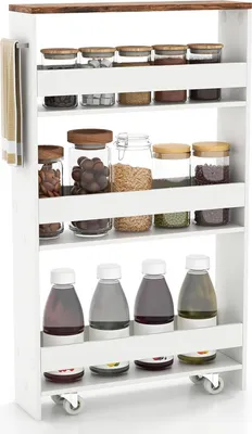 A white rolling storage cart with four shelves filled with various food items in jars and bottles.