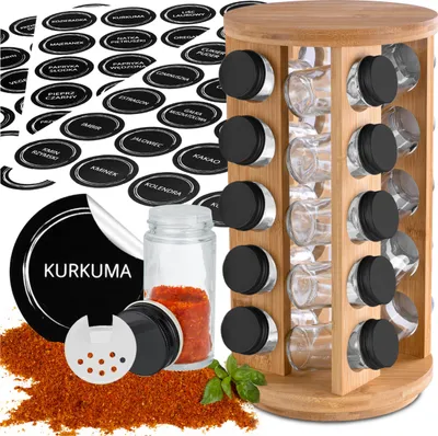 A rotating spice rack with spice jars and labels.