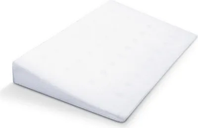 A white wedge pillow is shown on a white background.