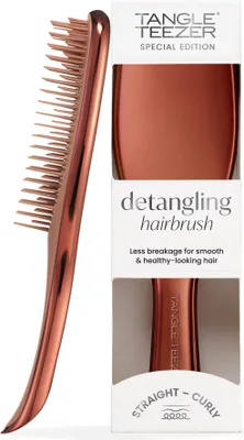 A Tangle Teezer detangling hairbrush in chrome bronze, presented with its packaging.