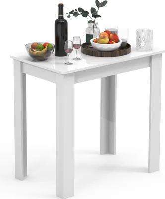 A white table with a bottle of wine, glasses, and fruit.