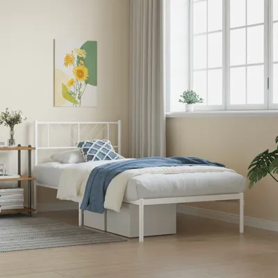 A white metal bed frame with a headboard is shown in a bedroom setting.