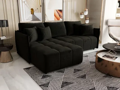 A modern living room scene featuring a black sectional sofa.