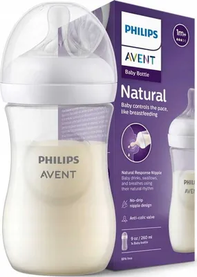 A Philips Avent baby bottle filled with milk, shown next to its packaging.