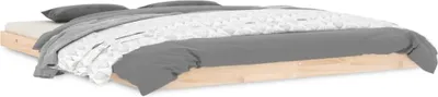 A low profile wooden bed frame with bedding.