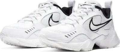 A pair of white Nike Air Heights women's sports shoes are shown against a white background.