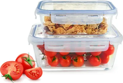 Two glass food storage containers stacked, one filled with cereal and the other with cherry tomatoes. Several cherry tomatoes are also placed in front of the containers.