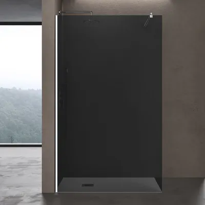 A modern black shower enclosure with a large window in the background.