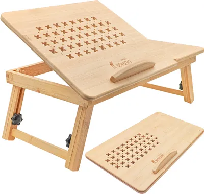 A wooden laptop table with adjustable legs and ventilation holes.