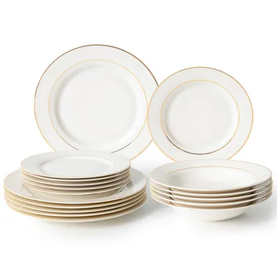 A set of white porcelain plates and bowls with gold trim, arranged on a white background.