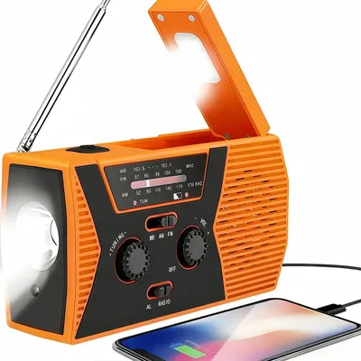 An orange and black emergency radio with a flashlight and an open lid, connected to a smartphone.
