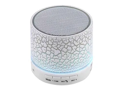 A white cylindrical Bluetooth speaker with a cracked texture and a mesh top, set against a white background.