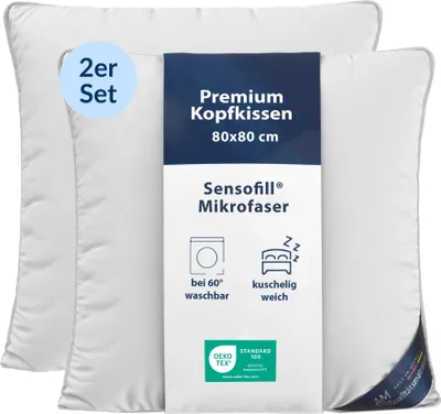 Two white pillows are shown, with a product information label attached to the front of one.