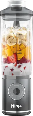 A blender filled with fruit and liquid, ready to be blended.