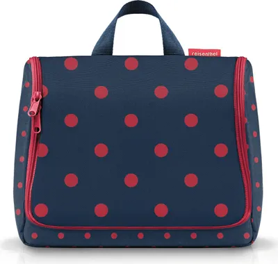 A navy blue toiletry bag with red polka dots and red trim, shown against a white background.