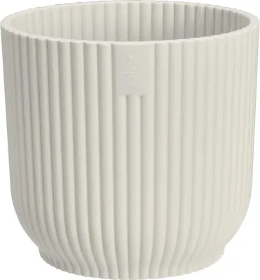 A white planter pot with vertical ridges.