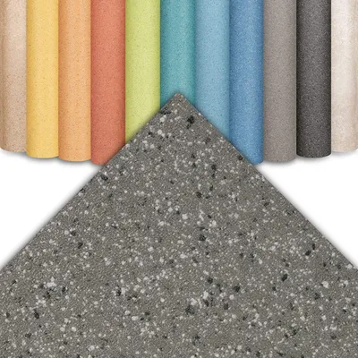 A collection of rolled-up samples of flooring material in various colors, with a large sample of speckled gray flooring material in the foreground.