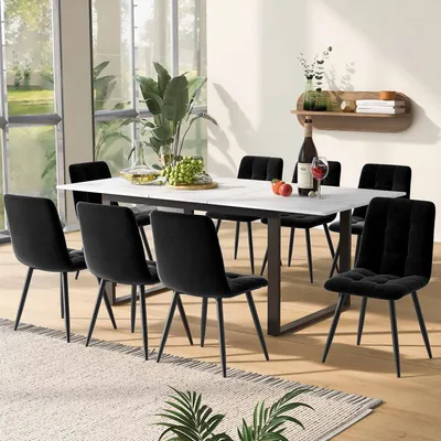 A dining room scene with a table and chairs, set for a meal.