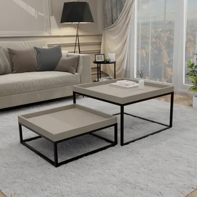 A living room scene with a sofa, coffee tables, and a window view.