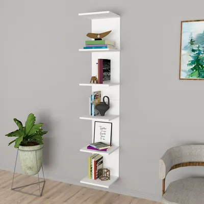 A white wall-mounted shelf unit with books and decorative items.