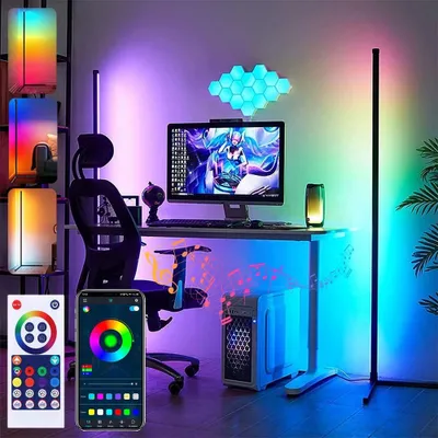 A modern gaming or home office setup with a computer, monitor, chair, and various LED lighting elements.