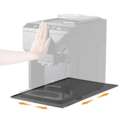 A hand is shown pressing on the top of a coffee machine, while a black drip mat is positioned in front of it, with arrows indicating it can be slid out.