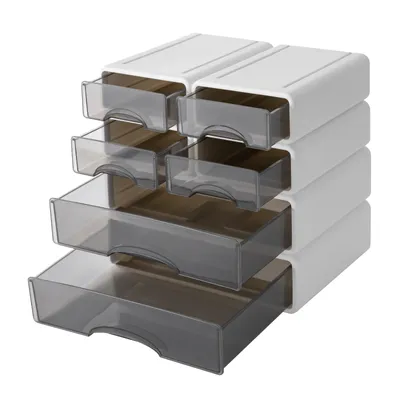 A stack of white and gray plastic drawer organizers against a white background.