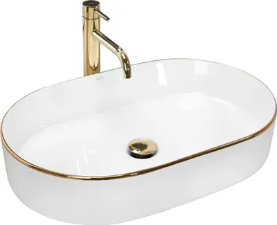 A white oval basin with a gold rim and a gold faucet.