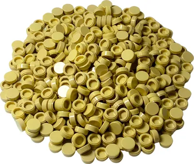 A pile of small, round, light beige LEGO tiles.