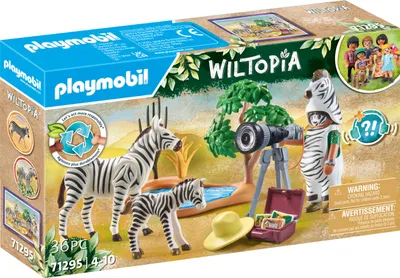 The image shows the packaging of a Playmobil Wiltopia toy set, featuring zebras, a toy figure, and accessories in a safari-like setting.