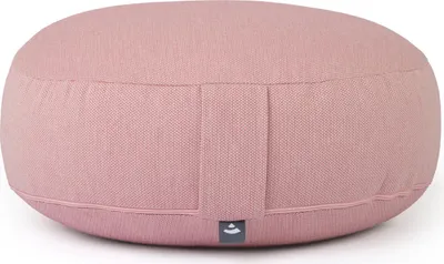 A close-up, front-facing view of a round, pink meditation cushion.