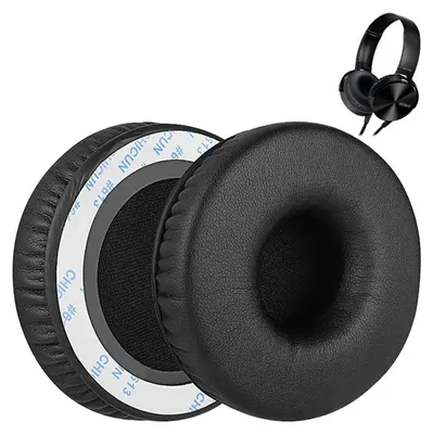 Two black ear pads for headphones are shown, with one slightly behind the other. A pair of black headphones is visible in the upper right corner.