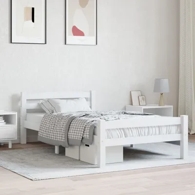 A white wooden bed frame in a minimalist bedroom setting.
