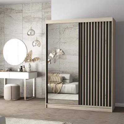 A bedroom scene featuring a wardrobe with mirrored and slatted doors, a vanity table with a round mirror, and decorative lighting.