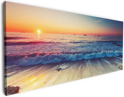 Produktbild von Wallario Premium Leinwandbild Sonnenuntergang am Meer mit Wellen am Strand in Größe 60 x 150 cm