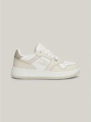 A single beige and white Tommy Hilfiger sneaker is shown against a plain light gray background.