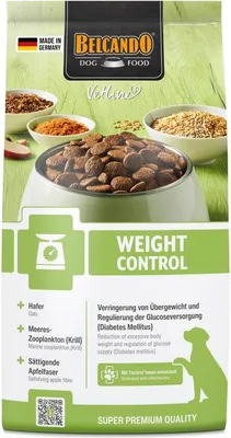 A bag of Belcando dog food with a bowl of kibble in the foreground and ingredients in the background.