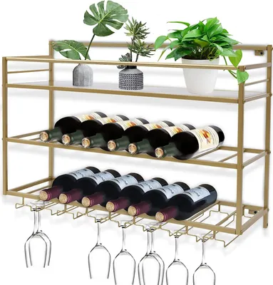 A gold-colored wine rack with bottles and glasses on shelves, with plants on the top shelf.