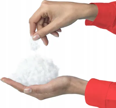 Hands holding and pouring white fluffy material.
