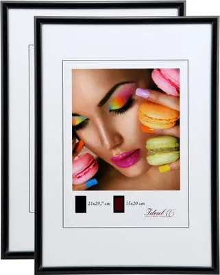 Two black picture frames are shown, one slightly behind the other. The front frame displays a close-up image of a woman's face with colorful makeup and macarons. Text indicating frame sizes and a brand logo are visible below the image.