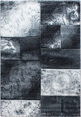 A close-up, top-down view of a rug with a modern, abstract design.