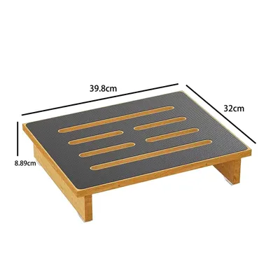 A wooden footrest with a textured black top.