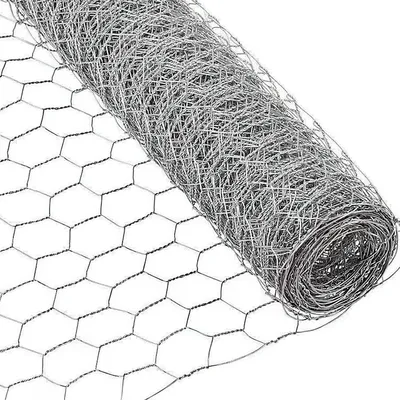 A roll of hexagonal wire mesh, also known as chicken wire or hardware cloth, is shown diagonally against a white background. The mesh is tightly rolled on the right side of the image, with the unrolled portion extending to the left, revealing its hexagonal