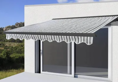 An awning is extended over a sliding glass door on the exterior of a building.