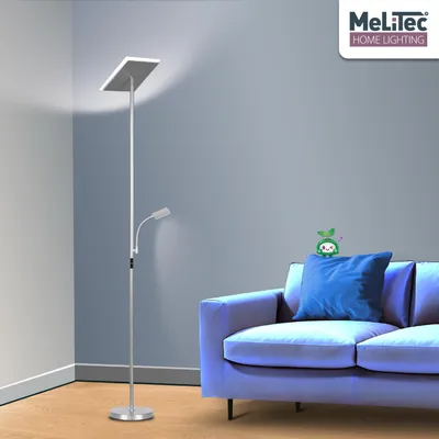 A floor lamp with a reading light is placed next to a sofa in a room.