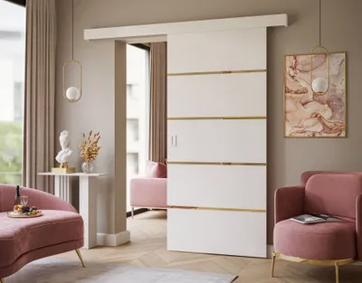 A modern living room with pink furniture and a white sliding door with gold accents.