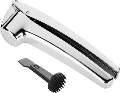 A shiny silver garlic press and a black cleaning tool are shown against a white background.