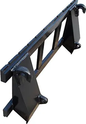 A black metal attachment for a front loader, likely for carrying pallets.