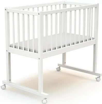 A white baby crib with a mattress on a white background.